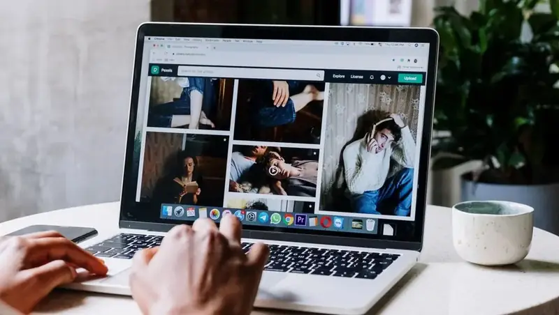 Content calendar on a laptop with AI-drafted social posts waiting for owner approval beside a phone showing a scheduled Instagram Reel